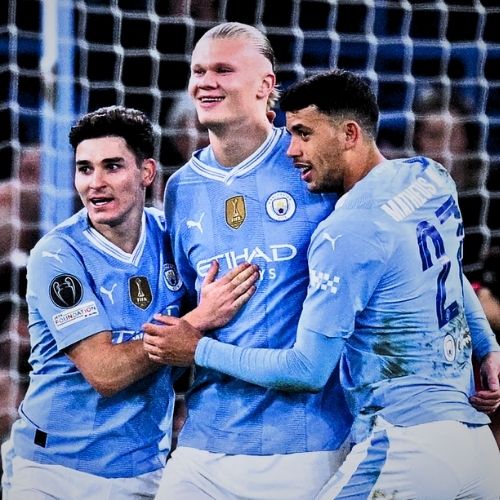 Erling Haaland celebrating his first goal with teammates including Matheus Nunes, wearing his debut club jersey
