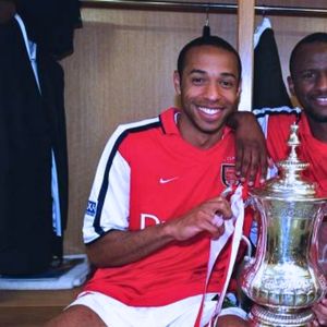 Thierry Henry celebrating Arsenal's FA Cup victory, wearing the red and white Arsenal Soccer Football kit