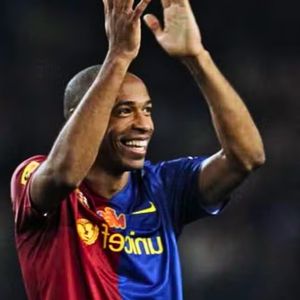 Thierry Henry posing alone in the Barcelona football kit, showcasing the team's colors